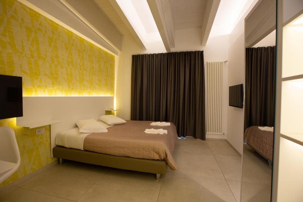 Postel nebo postele na pokoji v ubytování Hotel New Bari