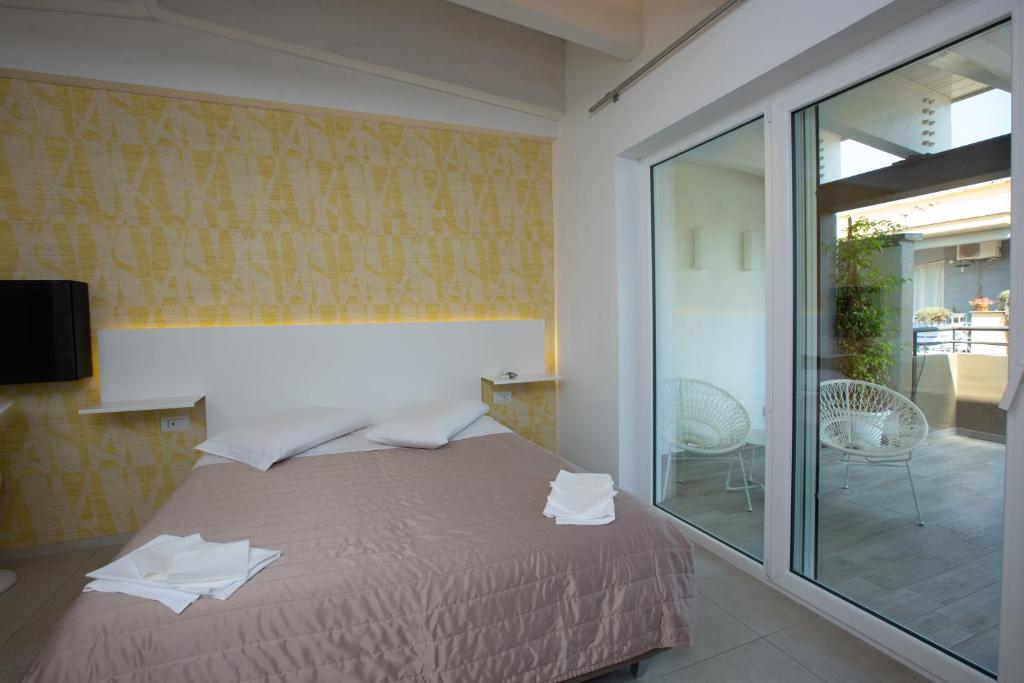 Postel nebo postele na pokoji v ubytování Hotel New Bari