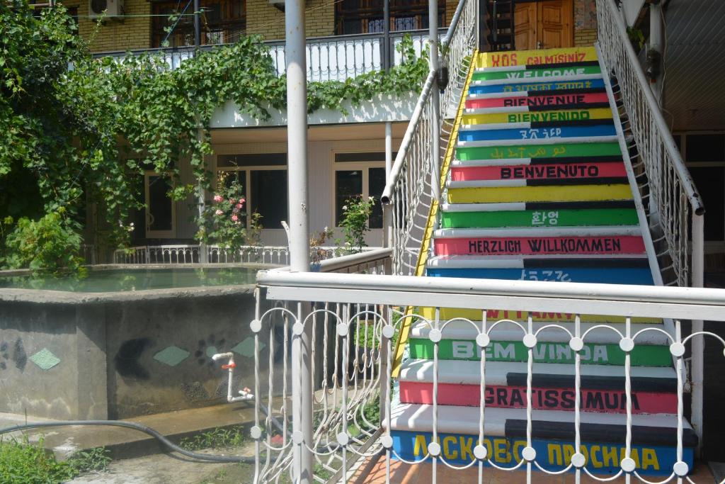 a stack of books on a staircase in front of a house at Canal Hostel in Sheki