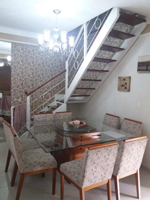 Residencial Castelo Branco في كامبيناس: غرفة طعام مع طاولة وكراسي زجاجية