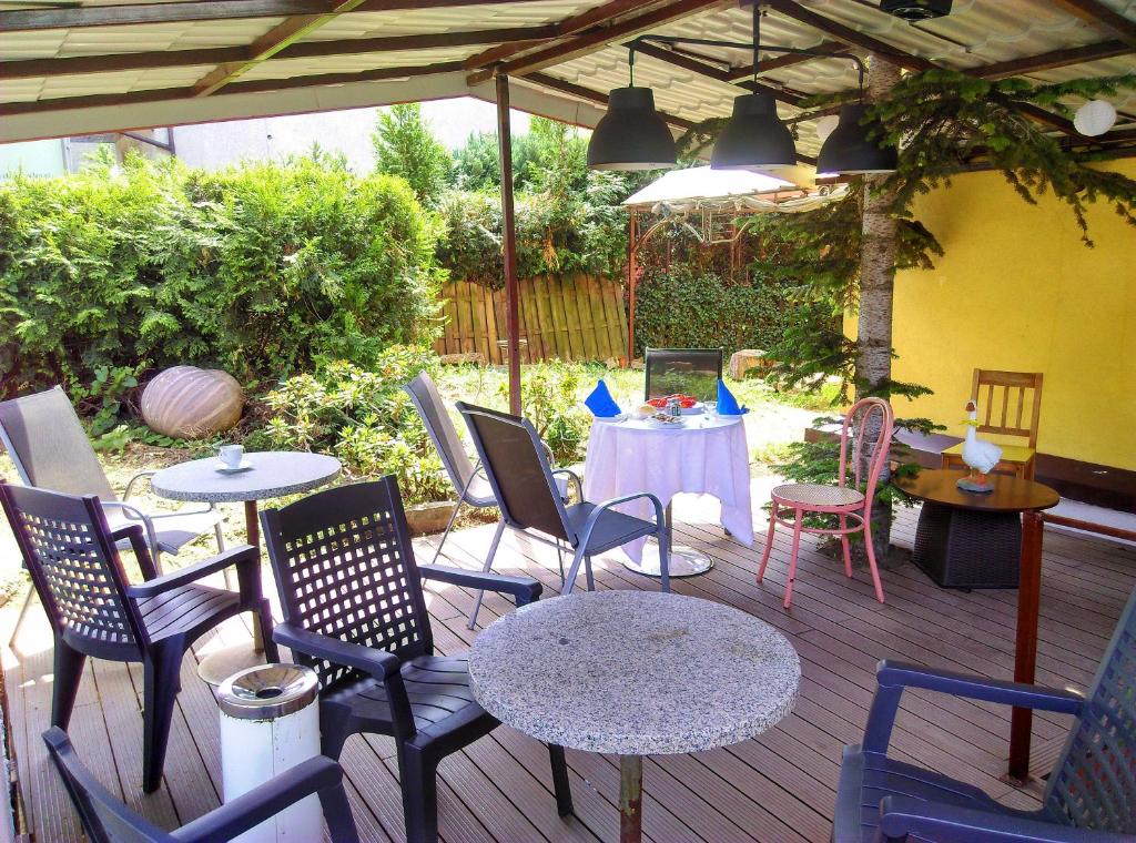 a patio with tables and chairs and a table and chairs at Motel Rezydent in Wrocław