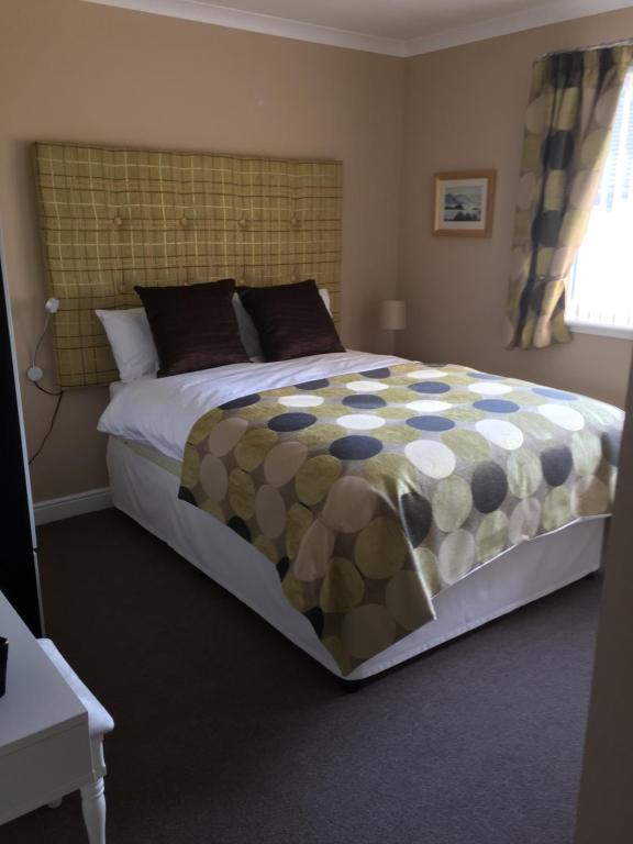 a bedroom with a large bed in a room at Coel Ila in Benderloch