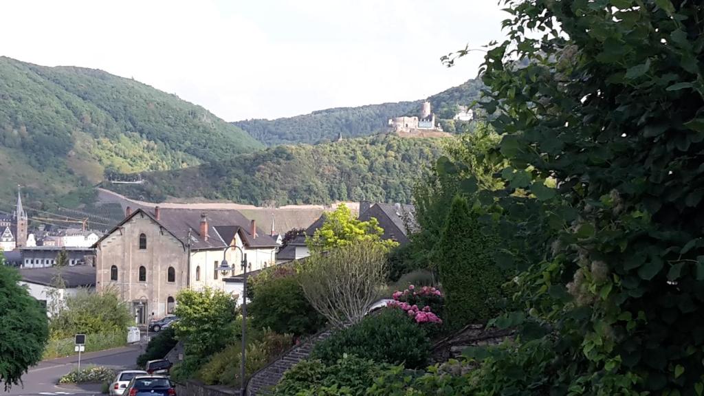 a town in the mountains with a castle on a hill at Milonia in Bernkastel-Kues