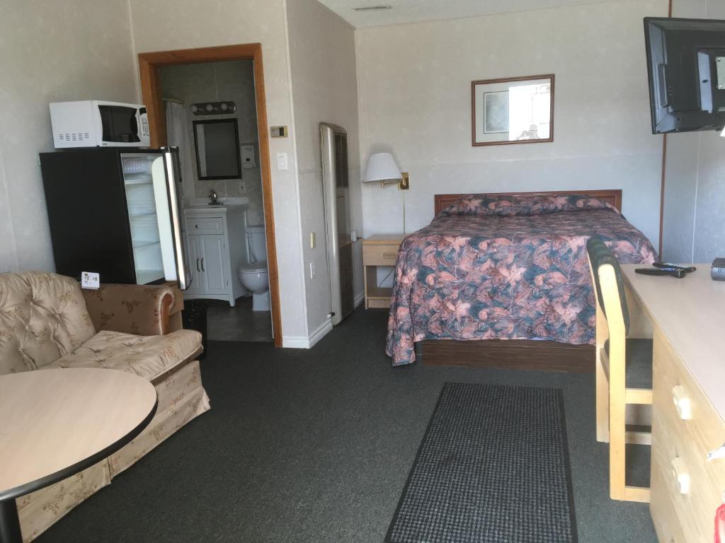 a hotel room with a bed and a couch at Winkys Motel in Estevan