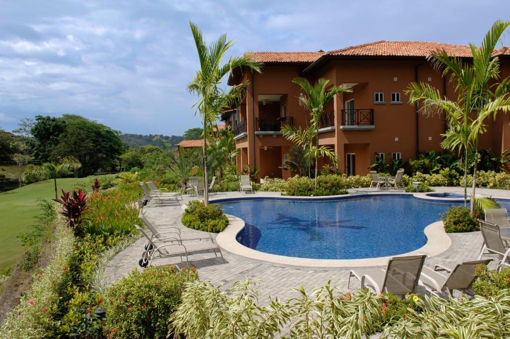a villa with a swimming pool and a resort at Los Suenos Resort Veranda 5A by Stay in CR in Herradura