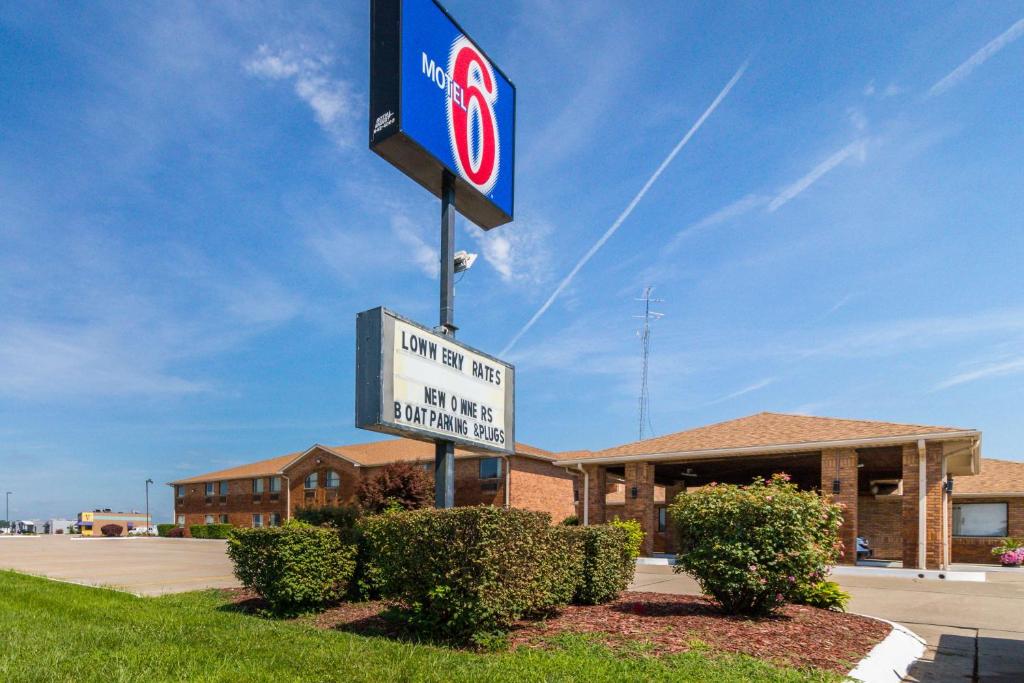 Motel 6-Marion, IL في ماريون: علامة على عمود أمام المبنى