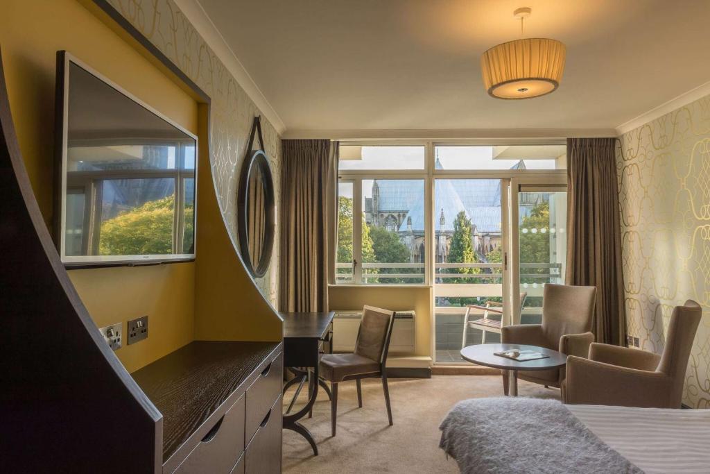 a hotel room with a bed and a table and chairs at The Lincoln Hotel in Lincoln