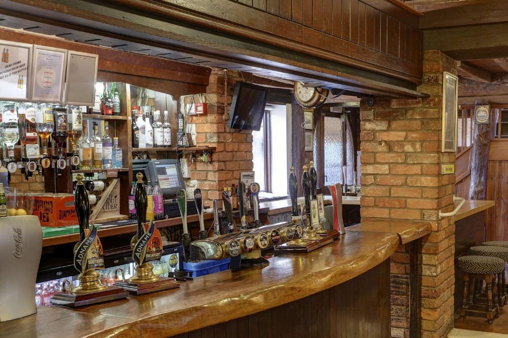 a bar in a pub with lots of alcohol at Old Hunstanton Le Strange Arms Hotel in Hunstanton