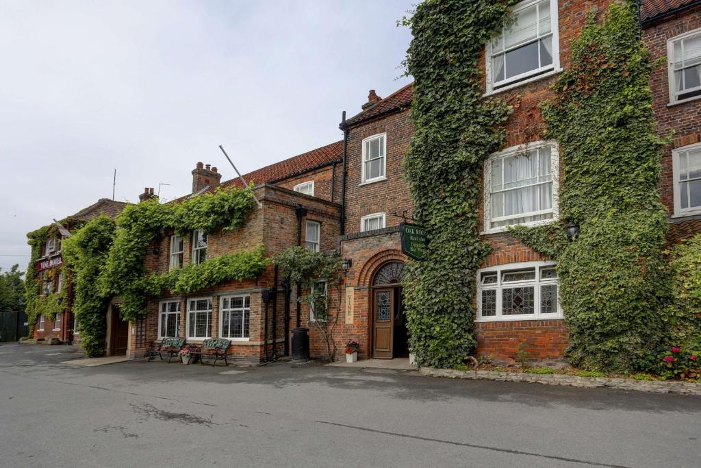 a brick building with ivy on the side of it at The Vine Hotel, Skegness in Skegness