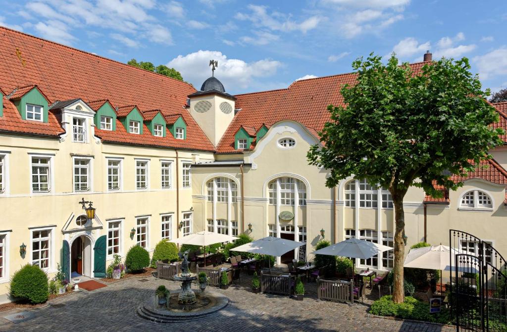 a large building with a clock on the front of it at Parkhotel Engelsburg in Recklinghausen