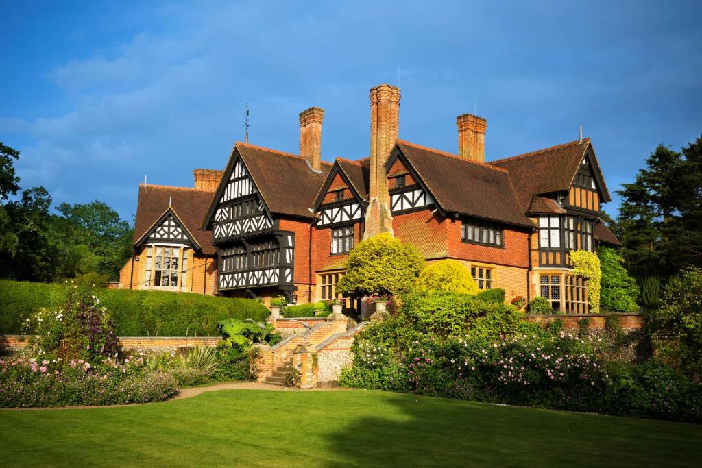 a large house with a garden in front of it at Best Western PLUS Grim's Dyke Hotel in Harrow