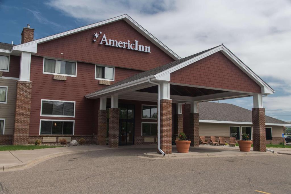 a red building with an americanan sign on it at AmericInn by Wyndham Mounds View Minneapolis in Mounds View