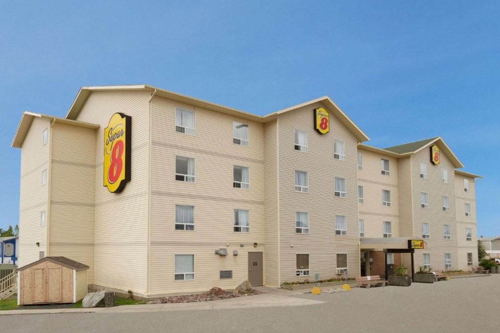 a large hotel building with a sign on it at Super 8 by Wyndham Yellowknife in Yellowknife
