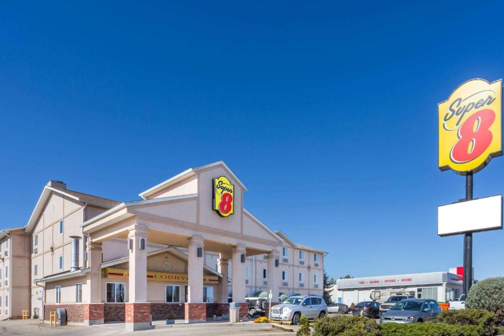 a building with a fast food restaurant and a sign at Super 8 by Wyndham Moose Jaw SK in Moose Jaw