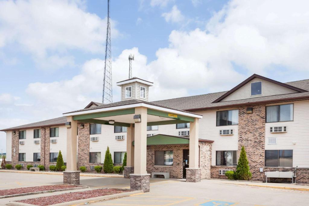 a large white building with a tower on top at Super 8 by Wyndham McLean/Bloomington SW in McLean