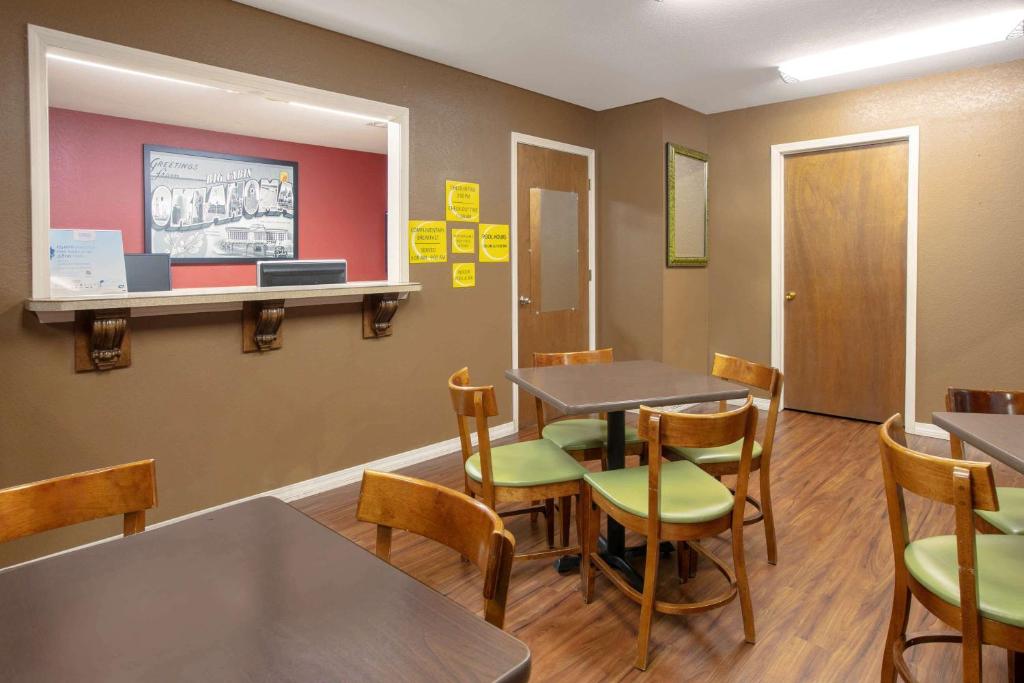 a waiting room with tables and chairs at Super 8 by Wyndham Big Cabin/Vinita Area in Vinita