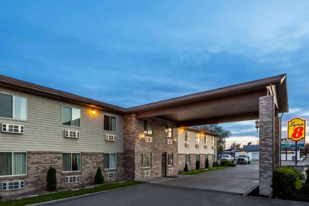 a hotel building with an overpass in front of it at Super 8 by Wyndham Rexburg in Rexburg
