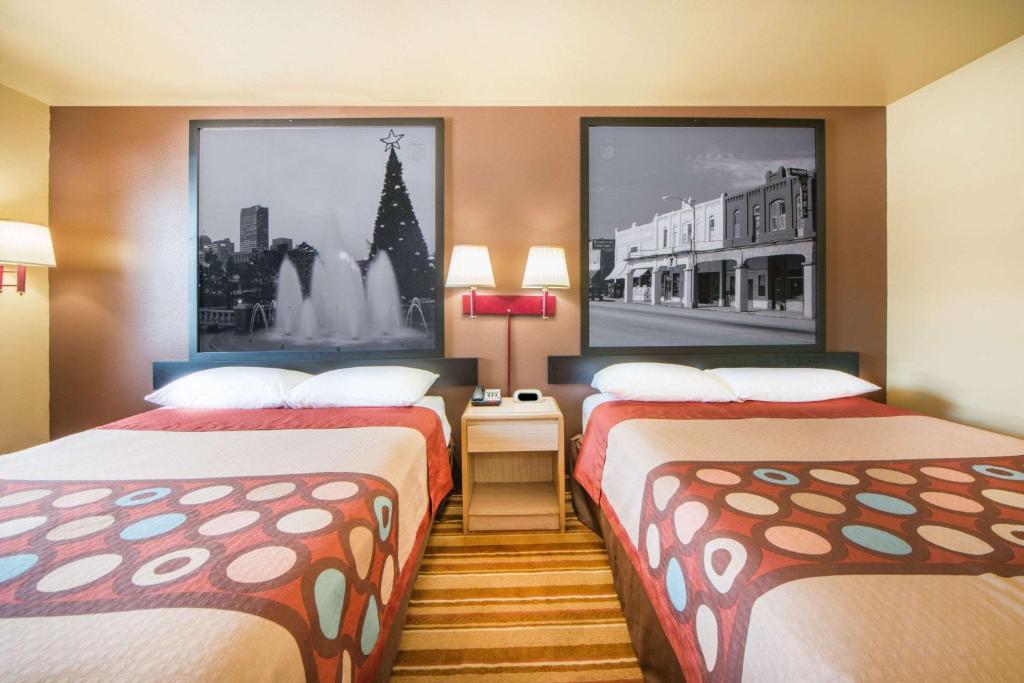 a hotel room with two beds and a street at Super 8 by Wyndham Big Cabin/Vinita Area in Vinita