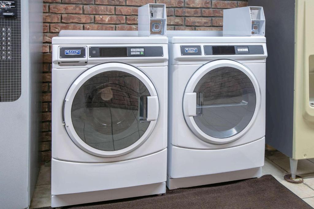 two washing machines are sitting next to each other at Super 8 by Wyndham Big Cabin/Vinita Area in Vinita
