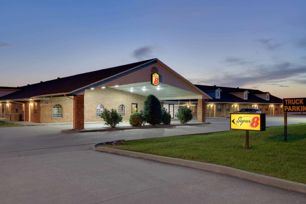 a large building with a sign in front of it at Super 8 by Wyndham Big Cabin/Vinita Area in Vinita