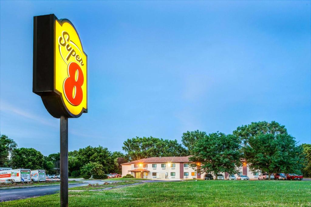 a gas station sign in front of a building at Super 8 by Wyndham Blair in Blair