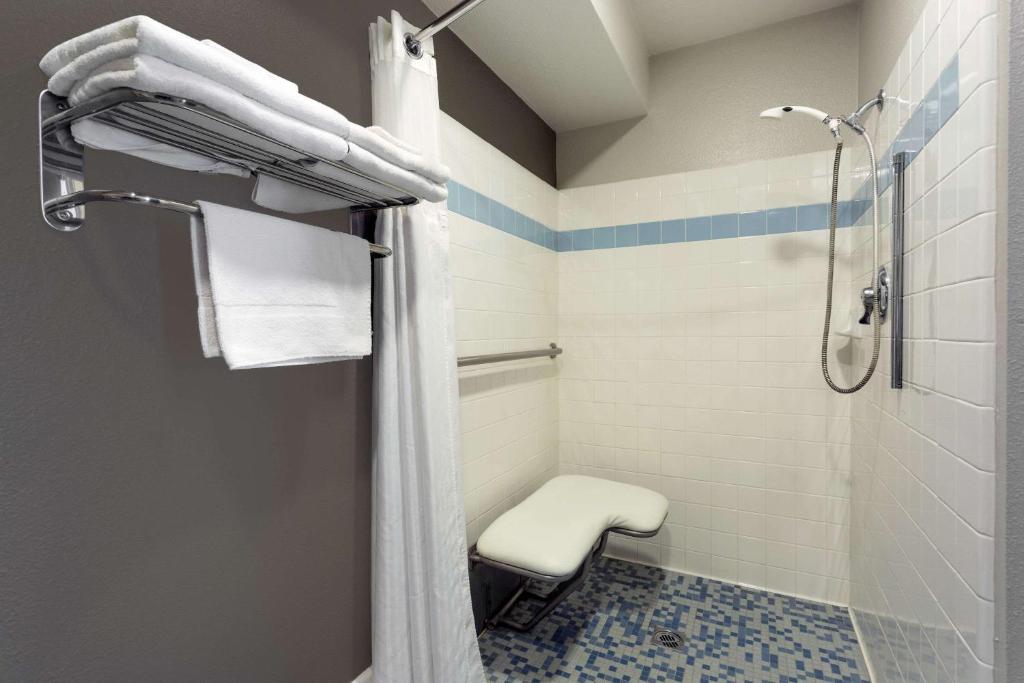 a bathroom with a shower and a toilet at Super 8 by Wyndham Fortuna in Fortuna