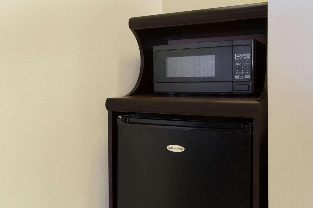 a microwave oven sitting on top of a refrigerator at Super 8 by Wyndham Fortuna in Fortuna