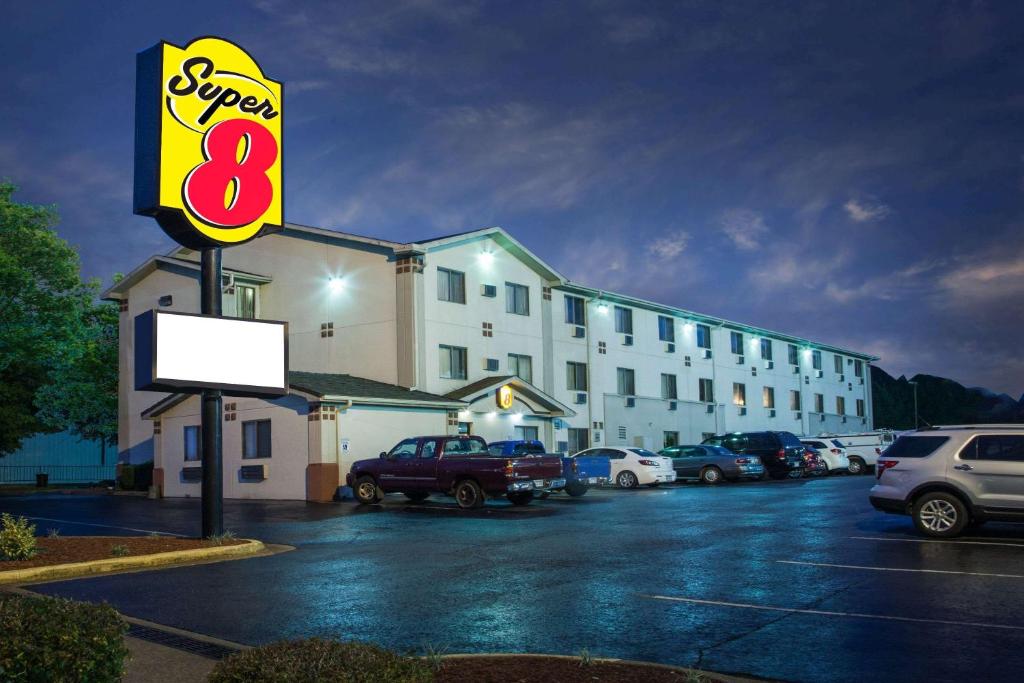 a store sign in front of a parking lot at Super 8 by Wyndham Hot Springs in Hot Springs