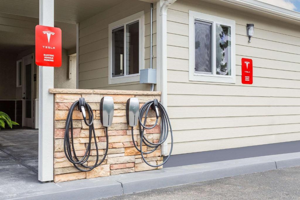 a house with hoses hanging on the side of it at Super 8 by Wyndham Fortuna in Fortuna