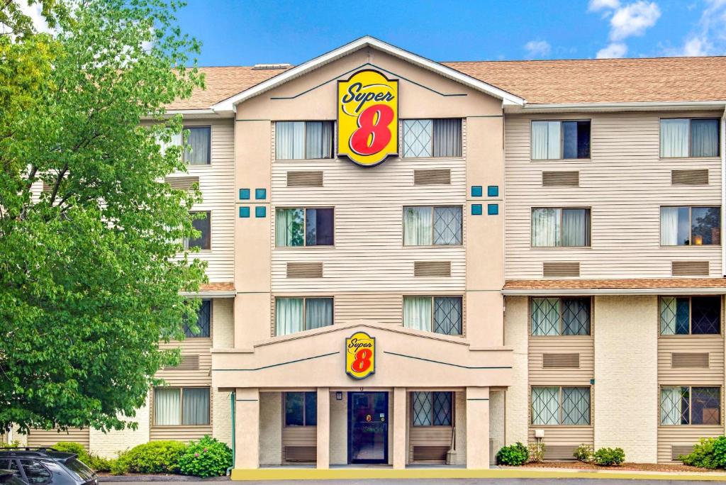 a hotel with a sign on the front of it at Super 8 by Wyndham Stamford/New York City Area in Stamford