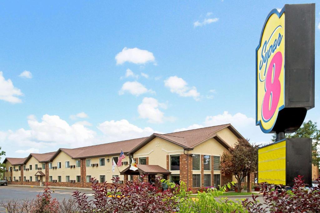 a hotel with a sign in front of it at Super 8 by Wyndham Longmont/Twin Peaks in Longmont