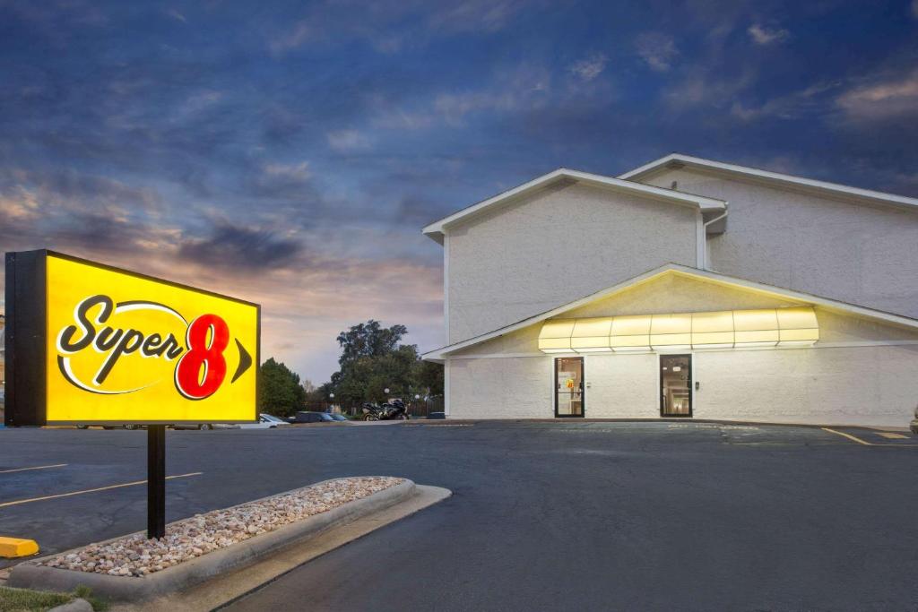 a sign in a parking lot in front of a store at Super 8 by Wyndham Columbus Airport in Columbus