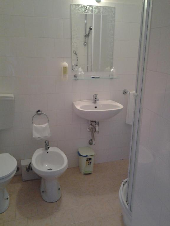 y baño con lavabo, aseo y ducha. en Hotel Touring, en Roma