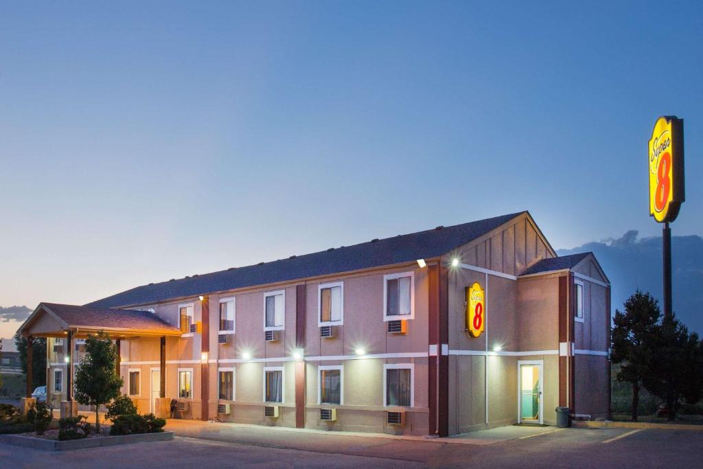 a building with a traffic light in front of it at Super 8 by Wyndham Limon in Limon