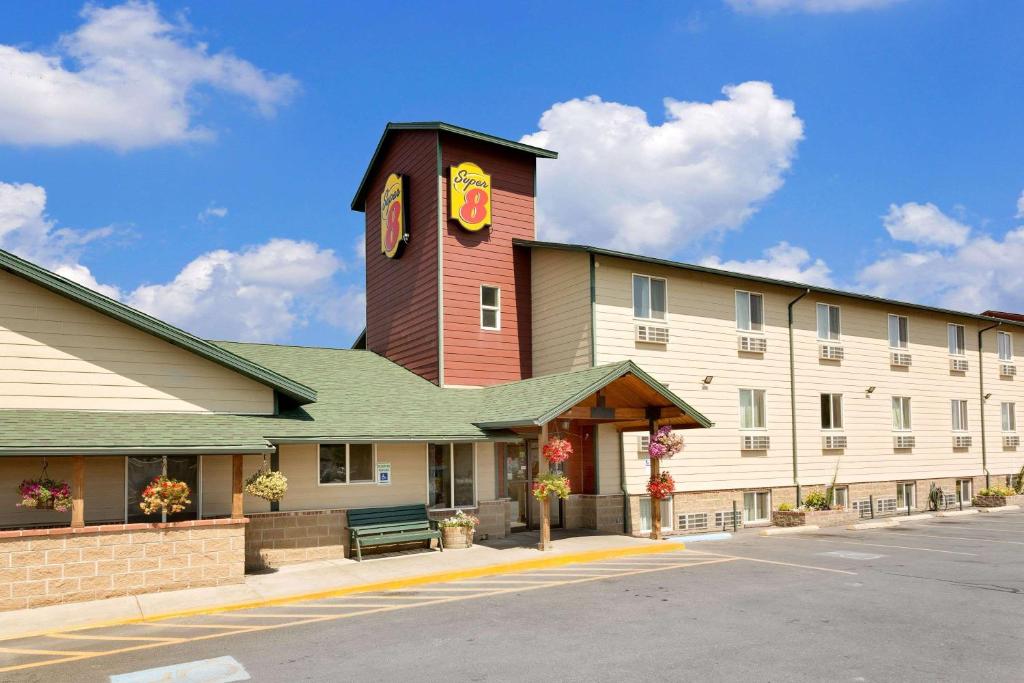 a building with a clock tower on top of it at Super 8 by Wyndham Belgrade/Bozeman Airport in Belgrade