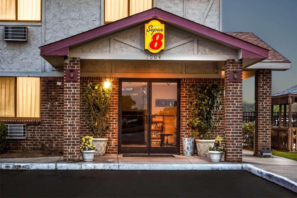 a restaurant with a sign on the front of a building at Super 8 by Wyndham Greenville in Greenville