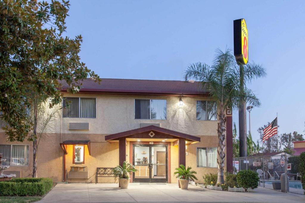 a building with a traffic light in front of it at Super 8 by Wyndham Selma/Fresno Area in Selma