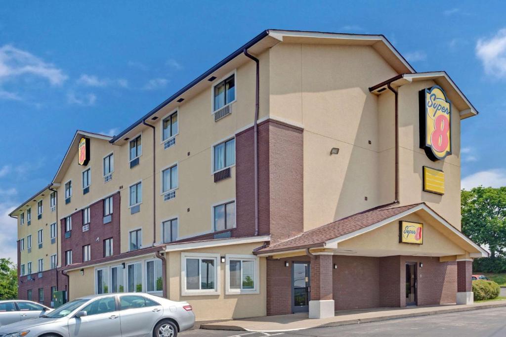 a hotel with a car parked in front of it at Super 8 by Wyndham Nashville/ Dntn/ Opryland Area in Nashville