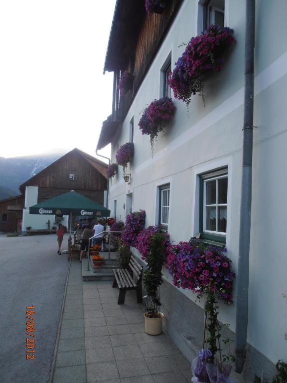 a building with flowers on the side of it at Huberbauer in Johnsbach