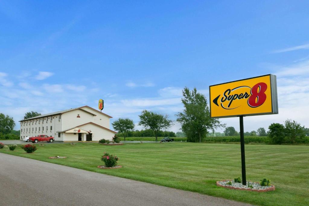 a sign for a super restaurant on the side of a road at Super 8 by Wyndham Saginaw in Saginaw