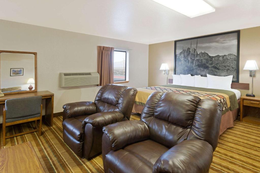 a hotel room with a bed and a couch at Super 8 by Wyndham Las Cruces/White Sands Area in Las Cruces