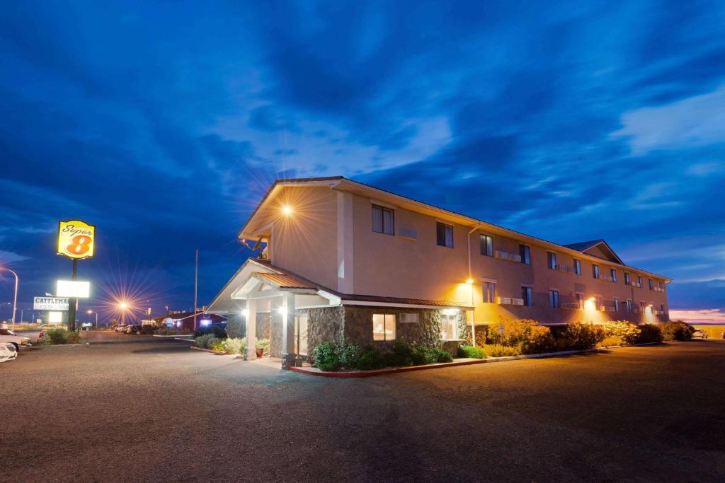 a building in a parking lot at night at Super 8 by Wyndham Las Cruces/White Sands Area in Las Cruces