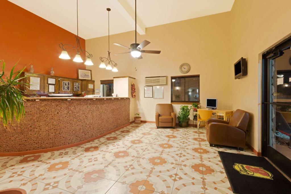 a living room with a bar and a dining room at Super 8 by Wyndham Las Cruces/White Sands Area in Las Cruces