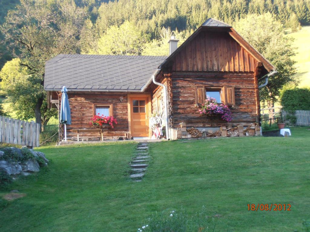 a log cabin with a lawn in front of it at Huberbauer in Johnsbach