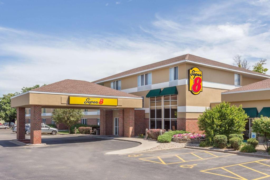 a mcdonalds restaurant with a sign in a parking lot at Super 8 by Wyndham Madison South in Madison