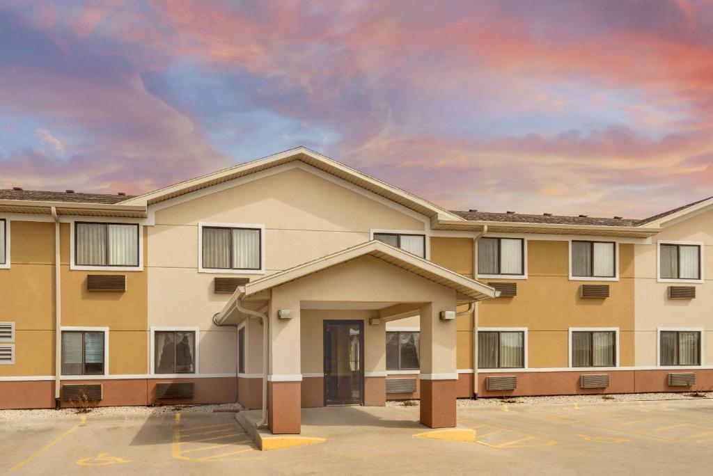 a apartment building with a parking lot at Super 8 by Wyndham Fond Du Lac in Fond du Lac