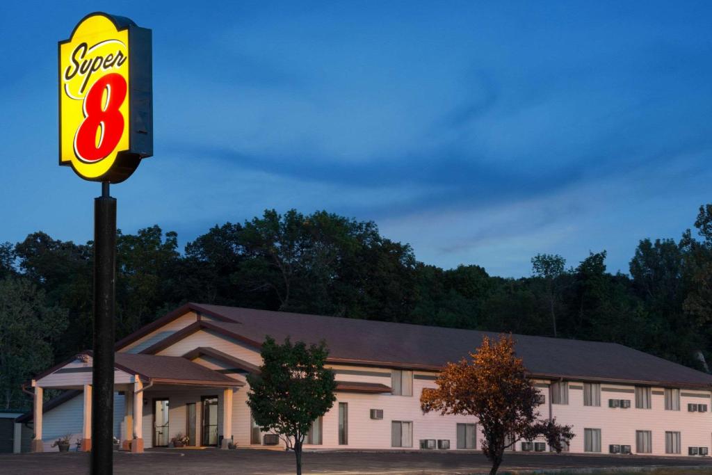 a gas station with a sign in front of it at Super 8 by Wyndham Algona in Algona