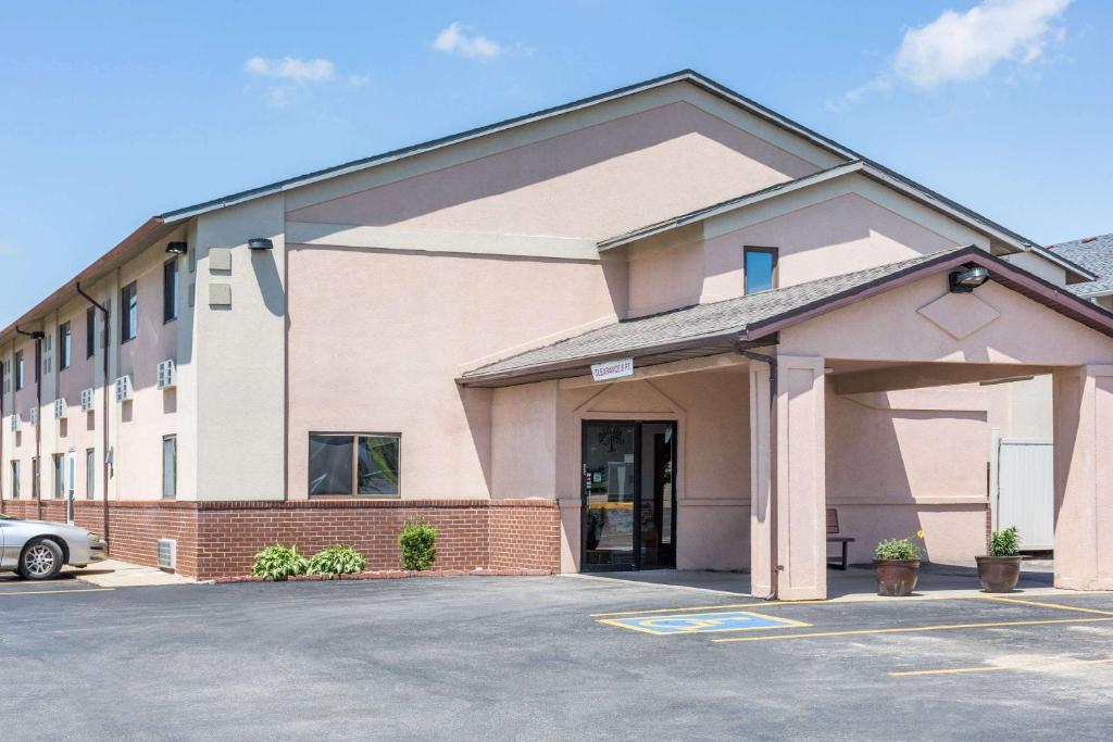 a building with a parking lot in front of it at Super 8 by Wyndham Osceola IA in Osceola