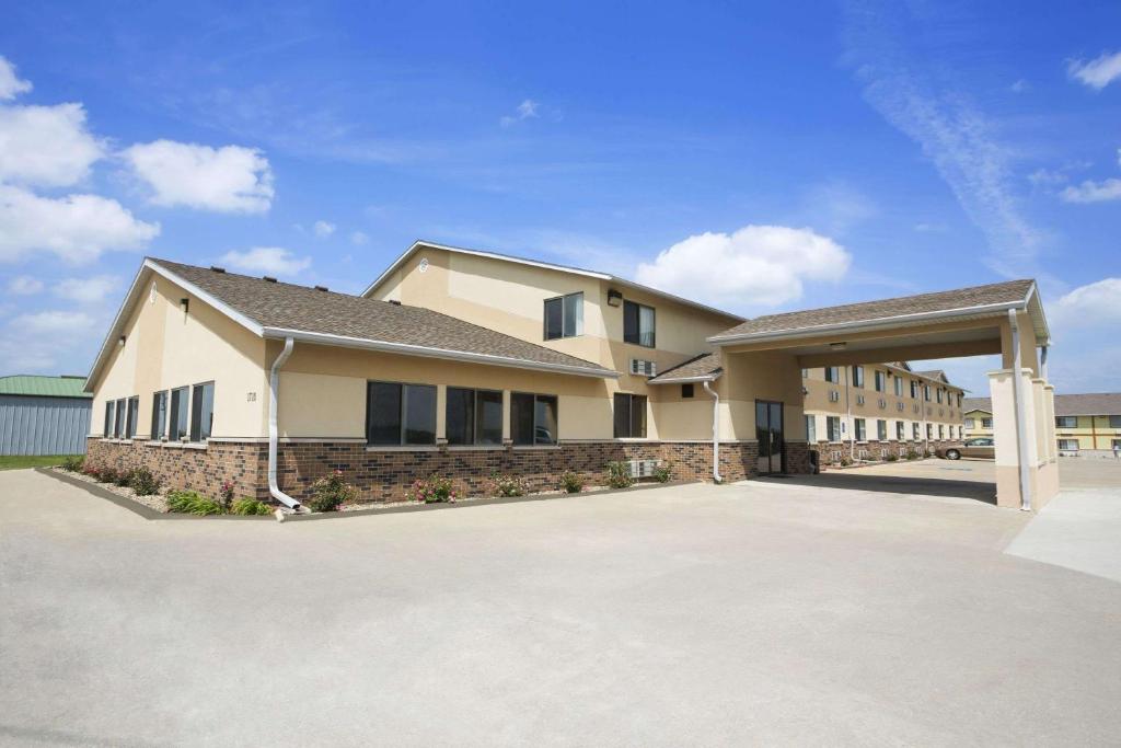 a large building with a driveway in front of it at Super 8 by Wyndham Cameron in Cameron