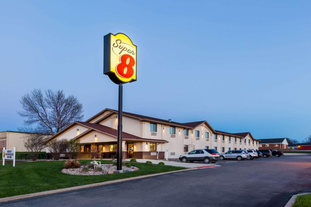 a motel sign in front of a building at Super 8 by Wyndham Spirit Lake/Okoboji in Spirit Lake